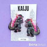 Kaiju Earrings Pink by Sylvia Draws